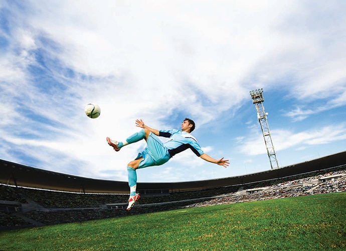 A soccer player playing soccer