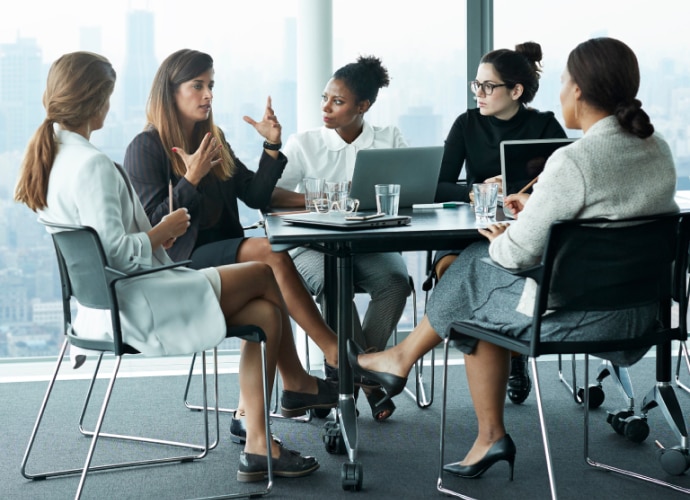 5 people in meeting room with cityscape in the background