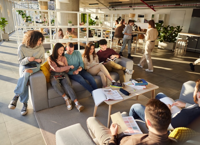 a group of students are sitting in the university lobby