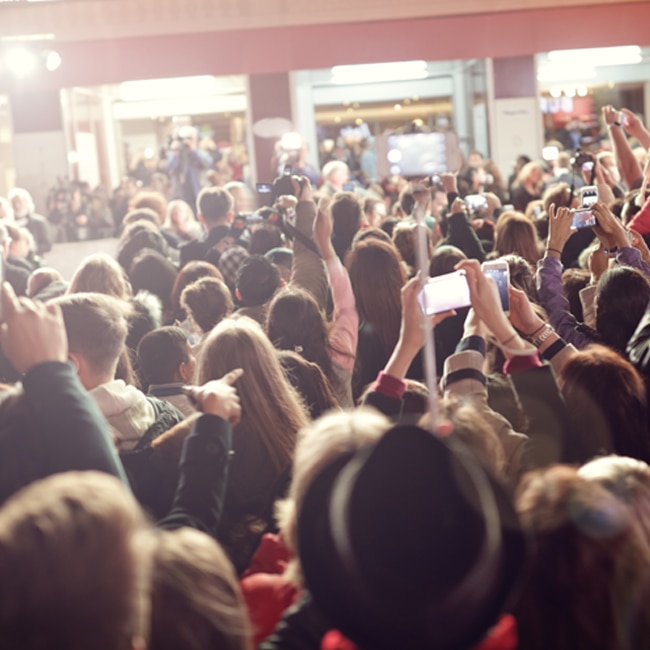 A crowd of people raising their hands