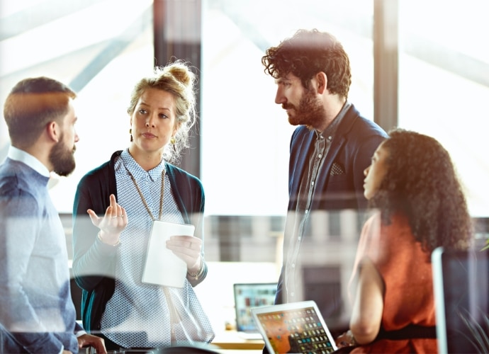 Colleagues discussing in an office environment