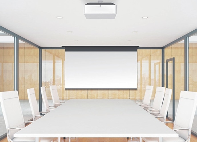 White boardroom with clear glass walls and projector hanging from the ceiling.