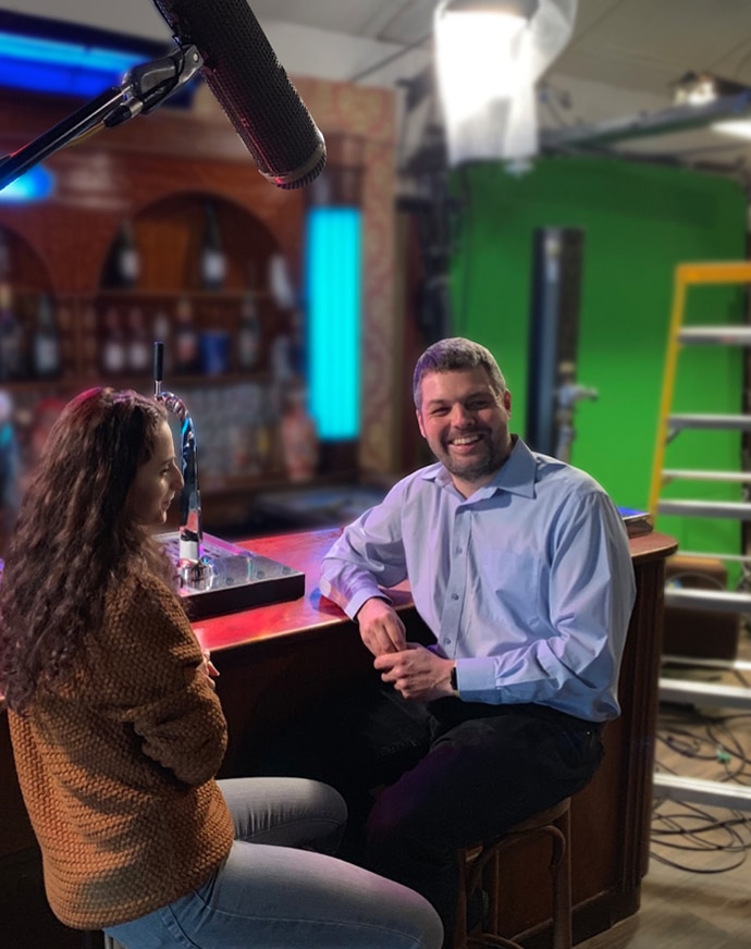 Behind-the-scenes bar scene with lead actor and actress