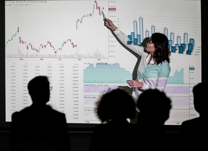 Woman presenting data to an audience.