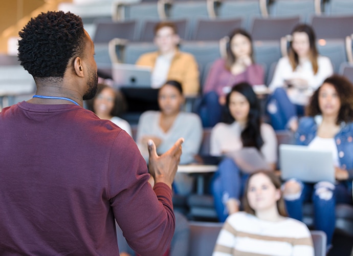 Man giving a lecture students TMV