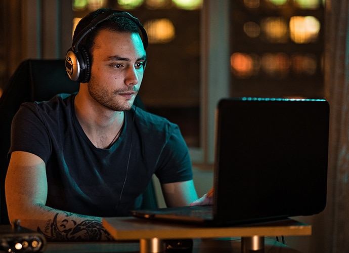 Man working at laptop with headphones