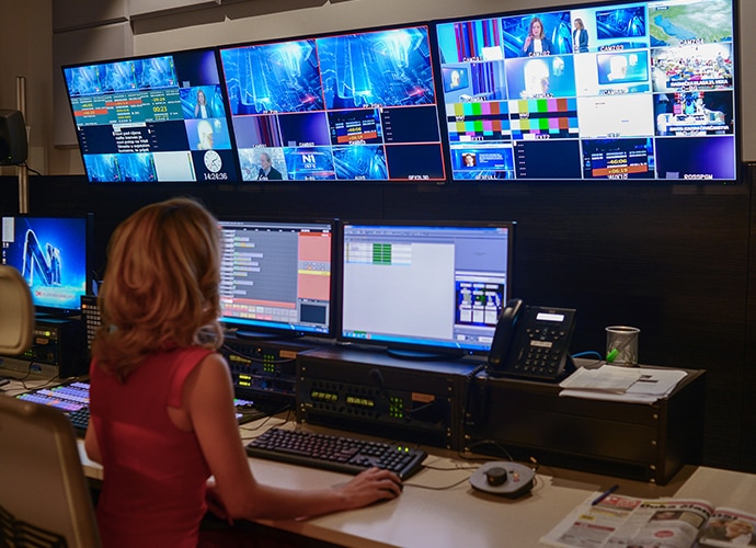 Lady Sitting in Control room studio filming