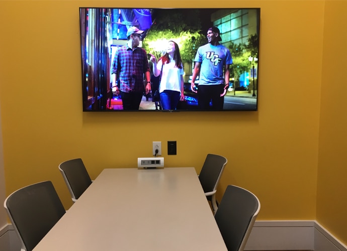 Image showing the interior of a meeting room, showing a UCF-themed image on the BRAVIA monitor.