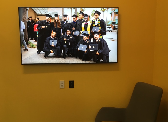 Image showing the interior of a breakout room, showing a UCF-themed image on the BRAVIA monitor.