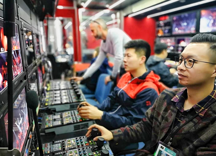 Chinese men using switchers to work on what has been filmed