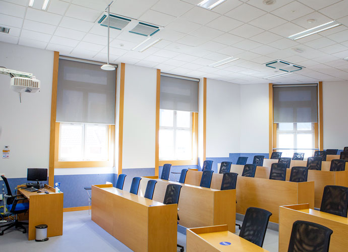 An empty classroom, with a ceiling-mounted Beamforming Microphone visible.