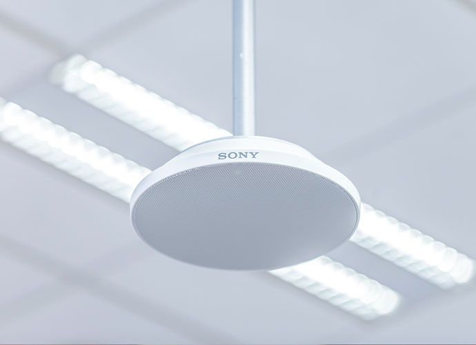 Image showing a closeup of a MAS-A100 Beamforming Microphone suspended from the ceiling.