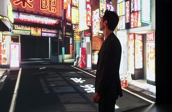 A man surveying a streetscene of Tokyo at night, rendered using Virtual Production