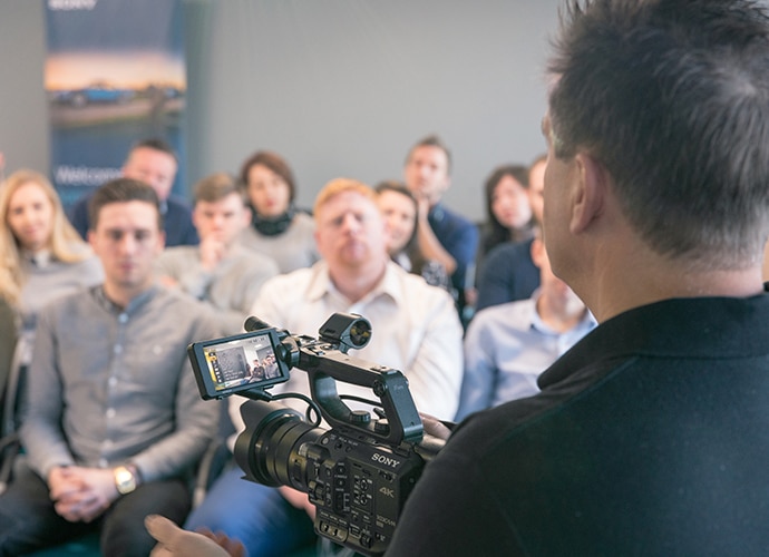 Man training his collogues with a Sony camera