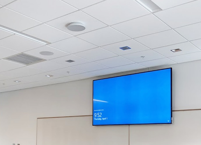 Classroom with a Sony BRAVIA TV mounted above the whiteboards