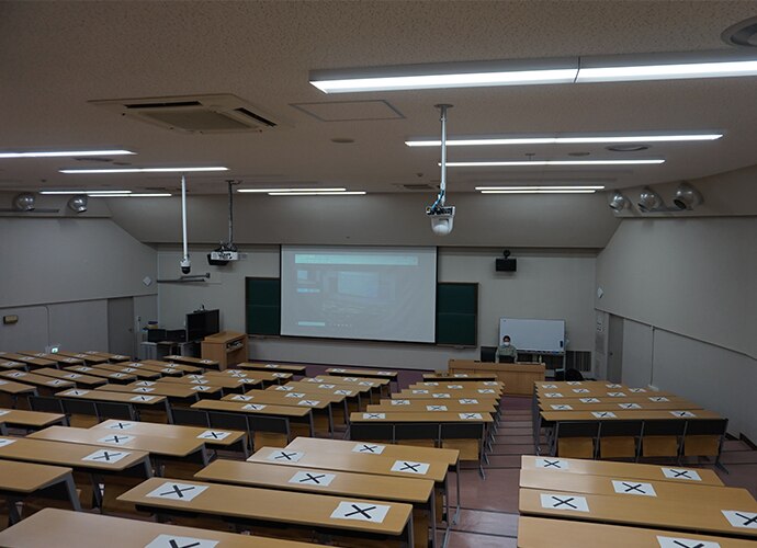 Shot of empty lecture hall with marked seating placement following social distancing