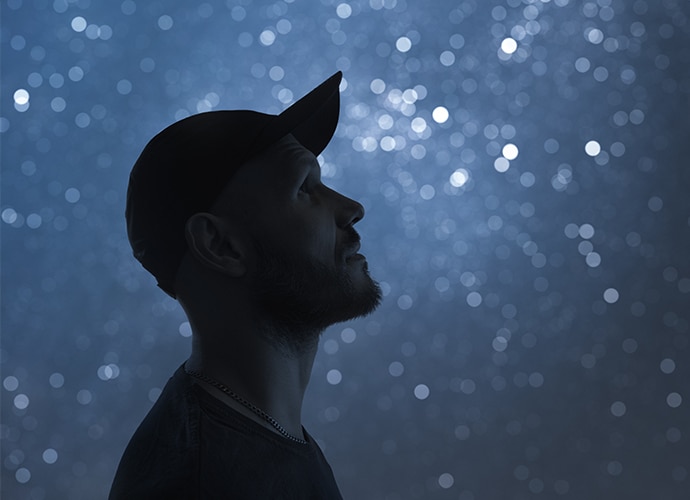 Side profile shot of a man wearing a hat.