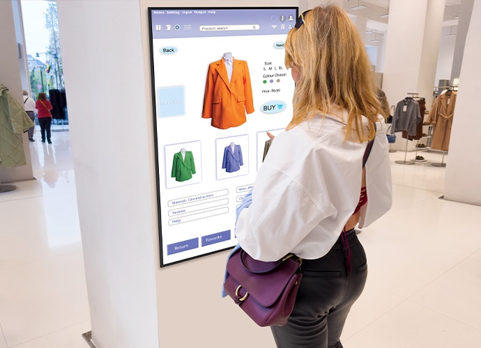 A woman standing in front of a Bravia display in a supermarket