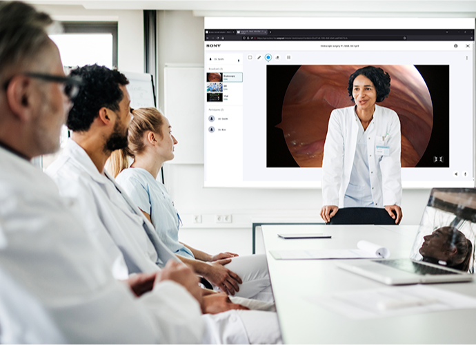 Doctors in meeting room see live surgical footage