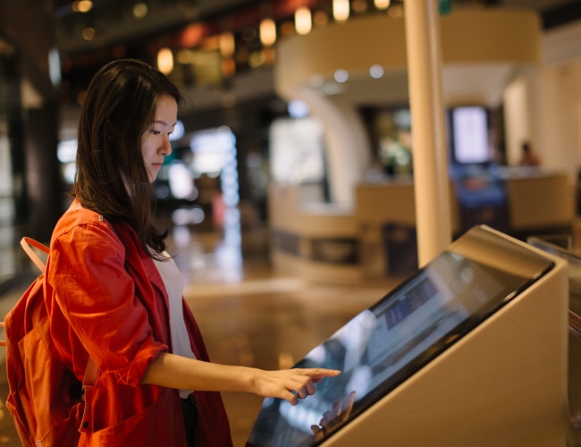 Customer touches screen of display with touchscreen overlay