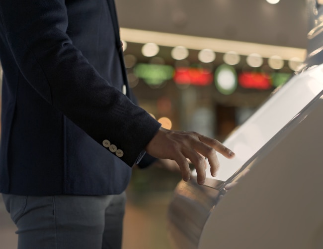 Customer touches screen of display with touchscreen overlay