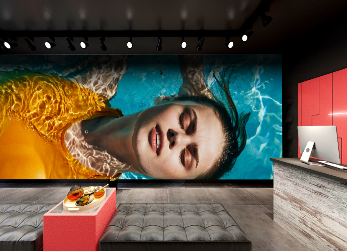 LED wall showcases a high brightness image of a woman in a swimming pool with an orange bathing suit