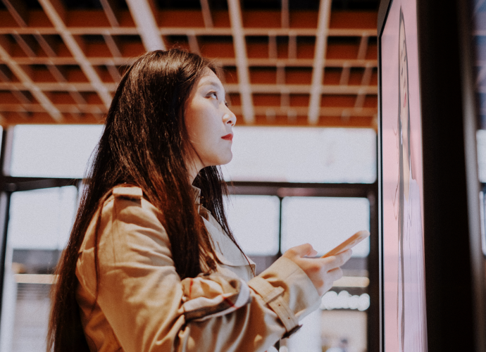 Woman touches screen in store