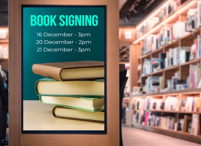 Book store with book signing dates announcement on professional display mounted on the wall