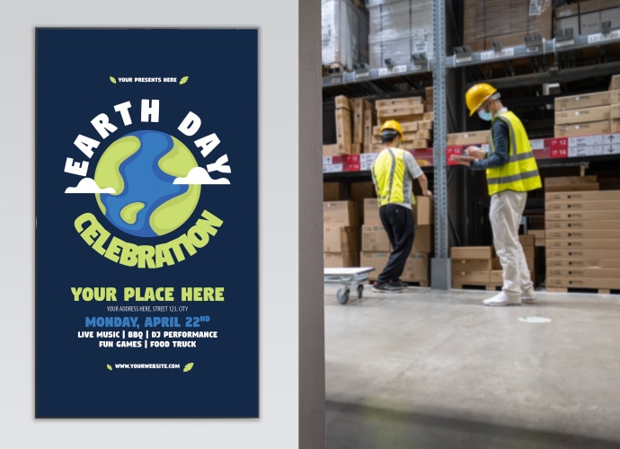 two workers in a warehouse with a professional display mounted on the wall with an “earth-day celebration” message