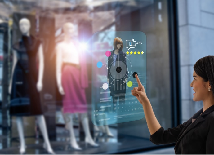 Woman touching a clothes display screen to change the colour of an outfit