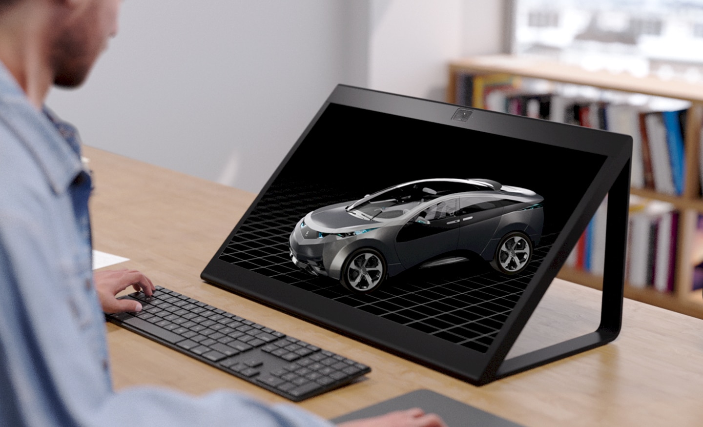 Close up photo of  user at a desk looking at a car design of he SR2 display.