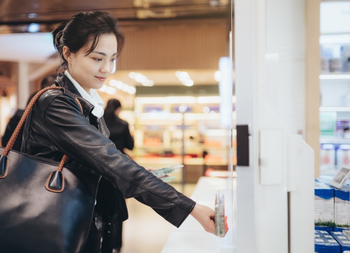 A woman scanning a beauty product on a store