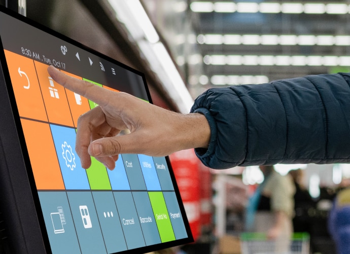 Woman scanning a product with self-checkout screen