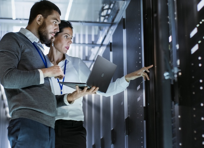 A woman and a man in a server room