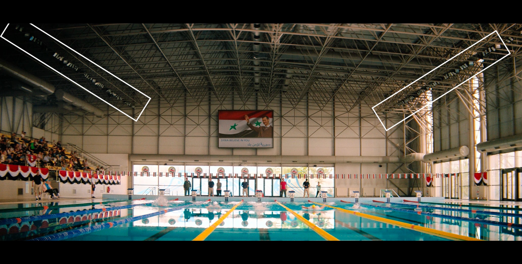 Swimming pool scene showing overhead lights dimmed