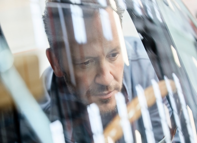 A man looking outside the window of a car