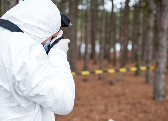 Forensic specialist is taking a picture of the crime scene using Sony camera.