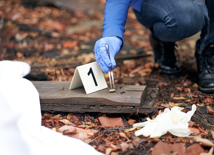 An investigator is numbering the evidence to take a photo.