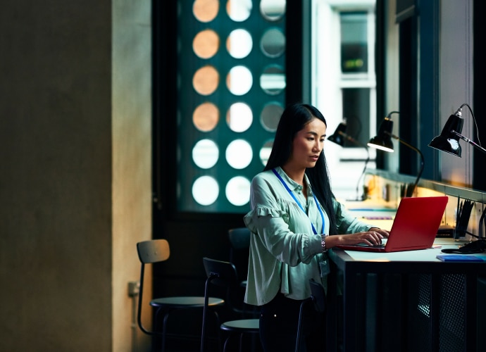 A woman working on a laptop.