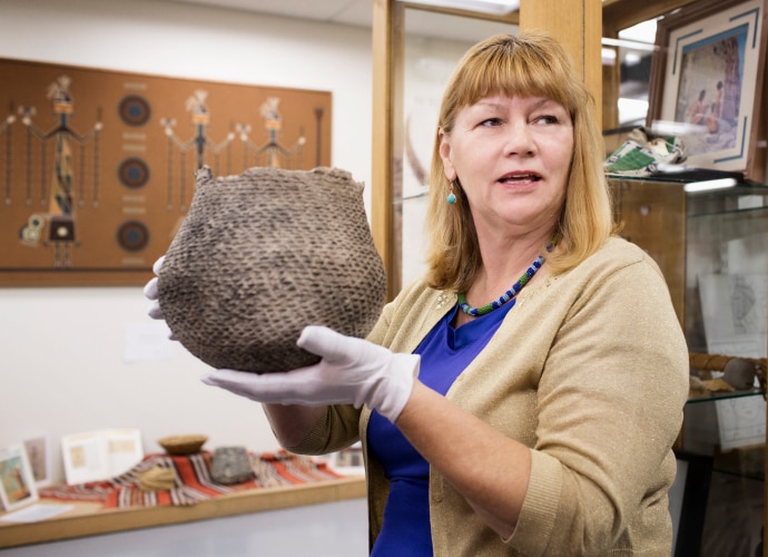 A woman holding an artifact.