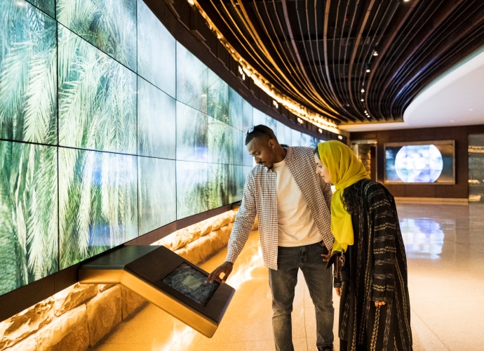 A man and a woman looking at a display.