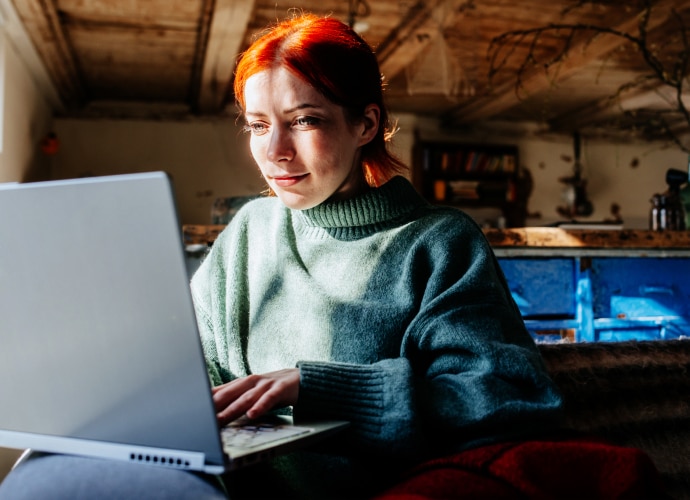 A woman working on a laptop.