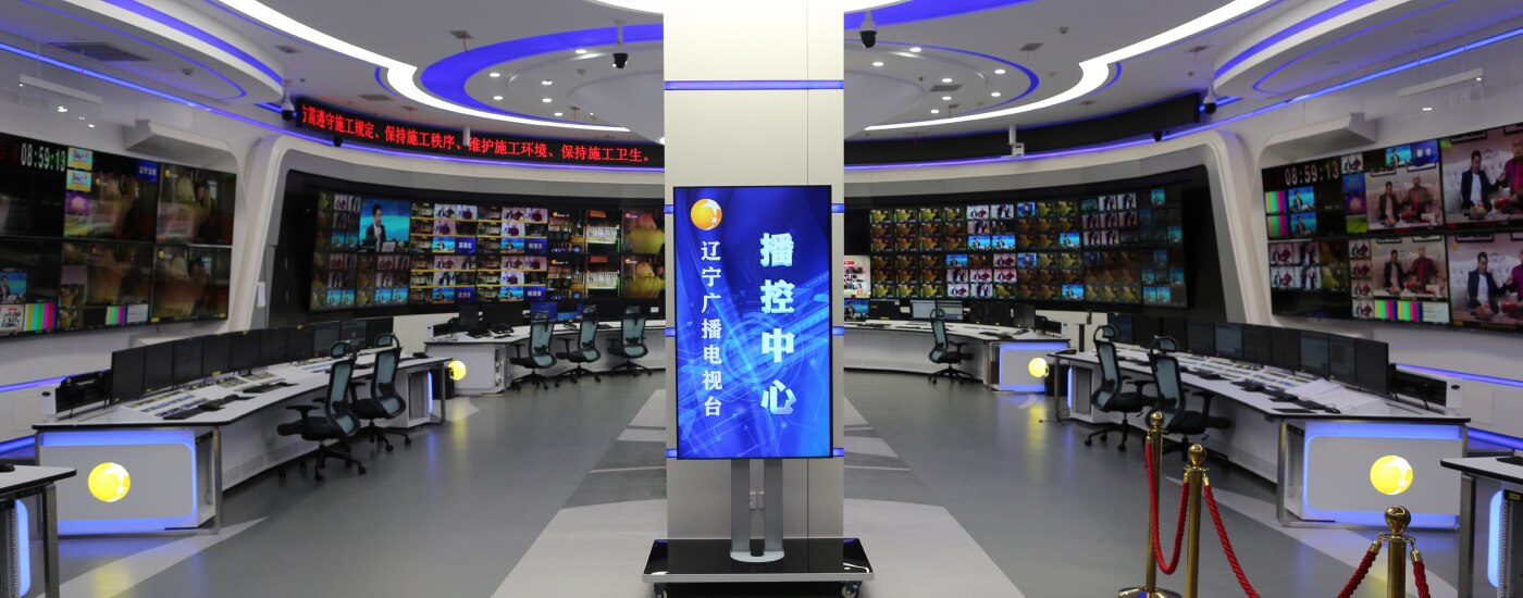 Full broadcast studio center with curved mosaic wall using large number of Bravia screens