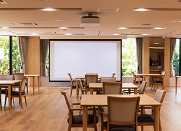 Nursing home communal area with display screen.