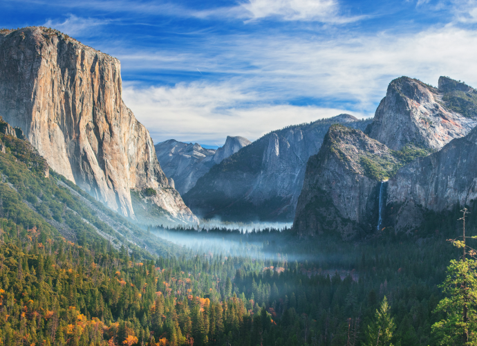 Landscape showing a national park with mountains and forest.