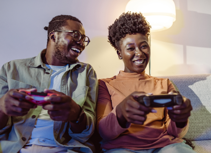 Two people playing games with their controllers.