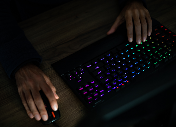 Hands using a keyboard and a mouse.