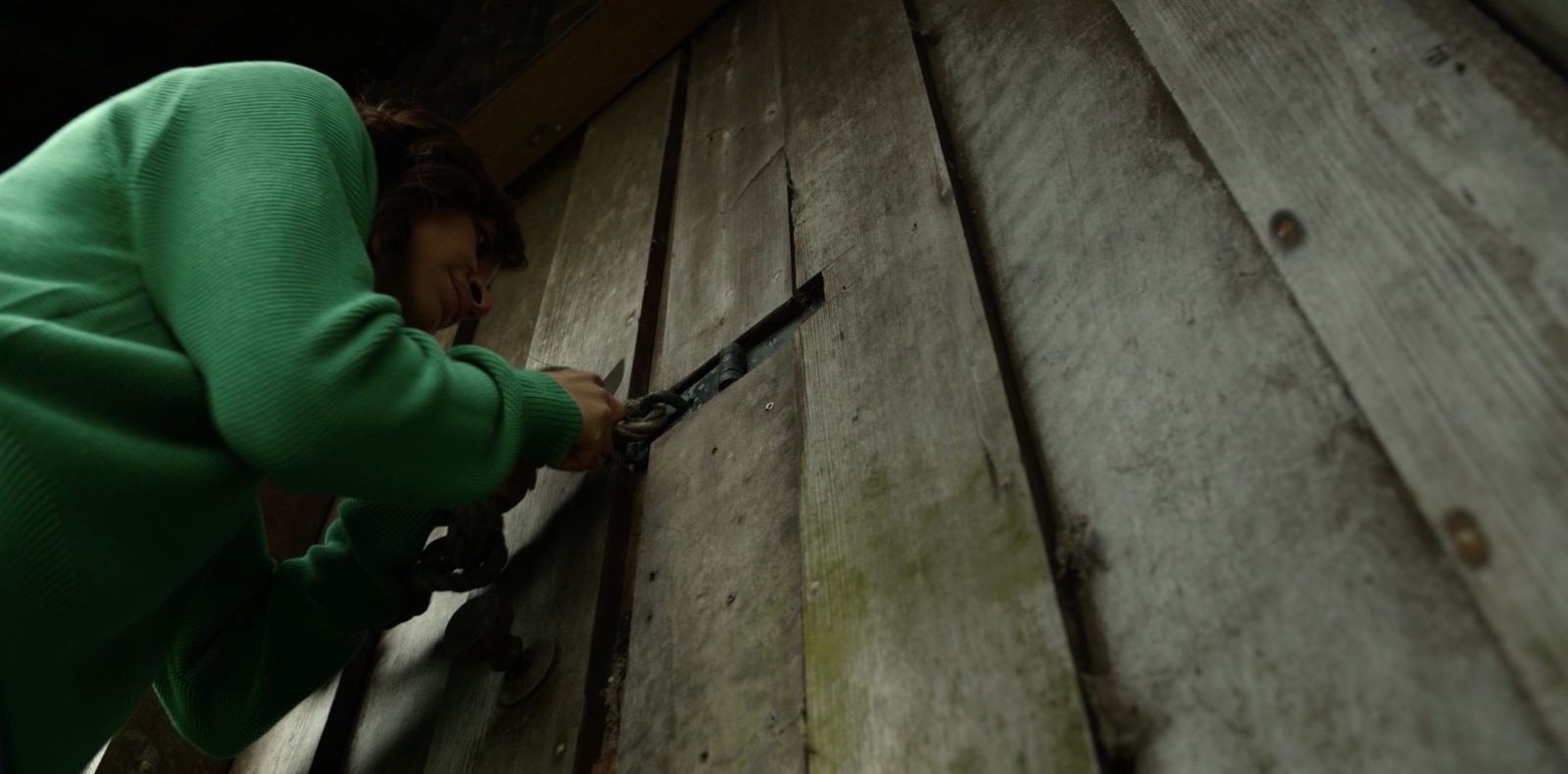 Close-up of opening the door of dilapidated building