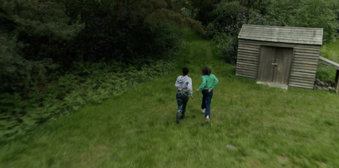 Overhead drone shot of two actors and shed