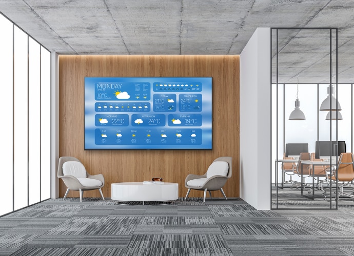 Office reception with large display screen showing weather information